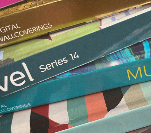 colorful Level printed catalogs stacked up, spines facing out